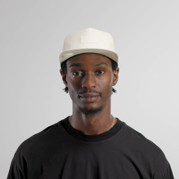 The model-image of the melin Split Crushed Fit Coronado Brick Hydro hat in egret