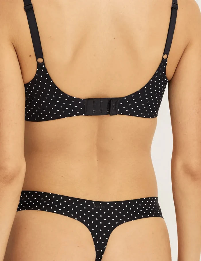 Sofia has 36.5” hips and wearing KNIX S | Back view of model wearing the Light Leakproof UltraThin No-Show Thong highlighting the coverage and smooth fit | Black with White Polka Dot
