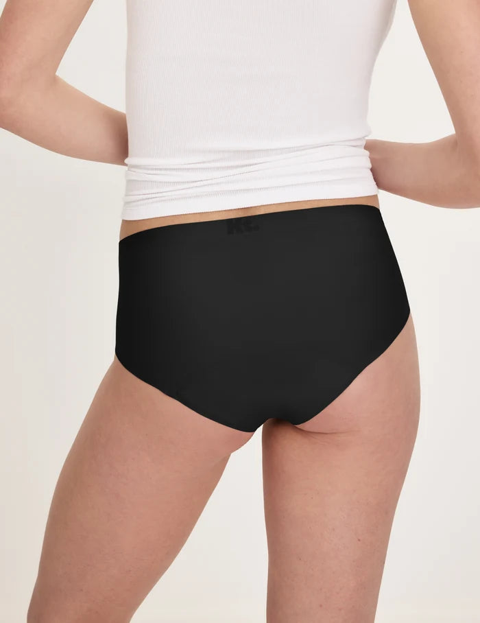 | Back view of model wearing the Teen Super Leakproof® No-Show Boyshort highlighting the coverage and smooth fit | Black