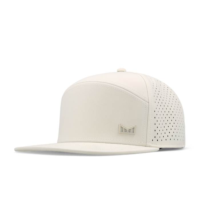 The angled view of the melin Horizon Fit Trenches Icon Hydro hat in egret