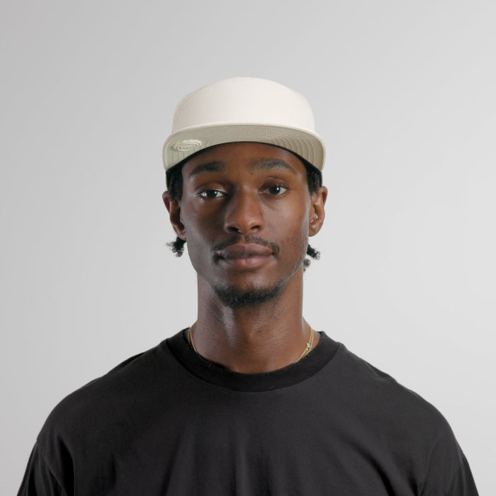 The model-image of the melin Horizon Fit Trenches Icon Hydro hat in egret