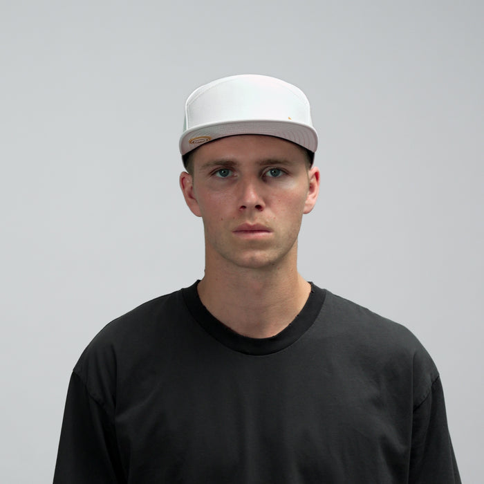 The model-image of the Melin Horizon Fit Trenches Icon Hydro hat in White / Gum